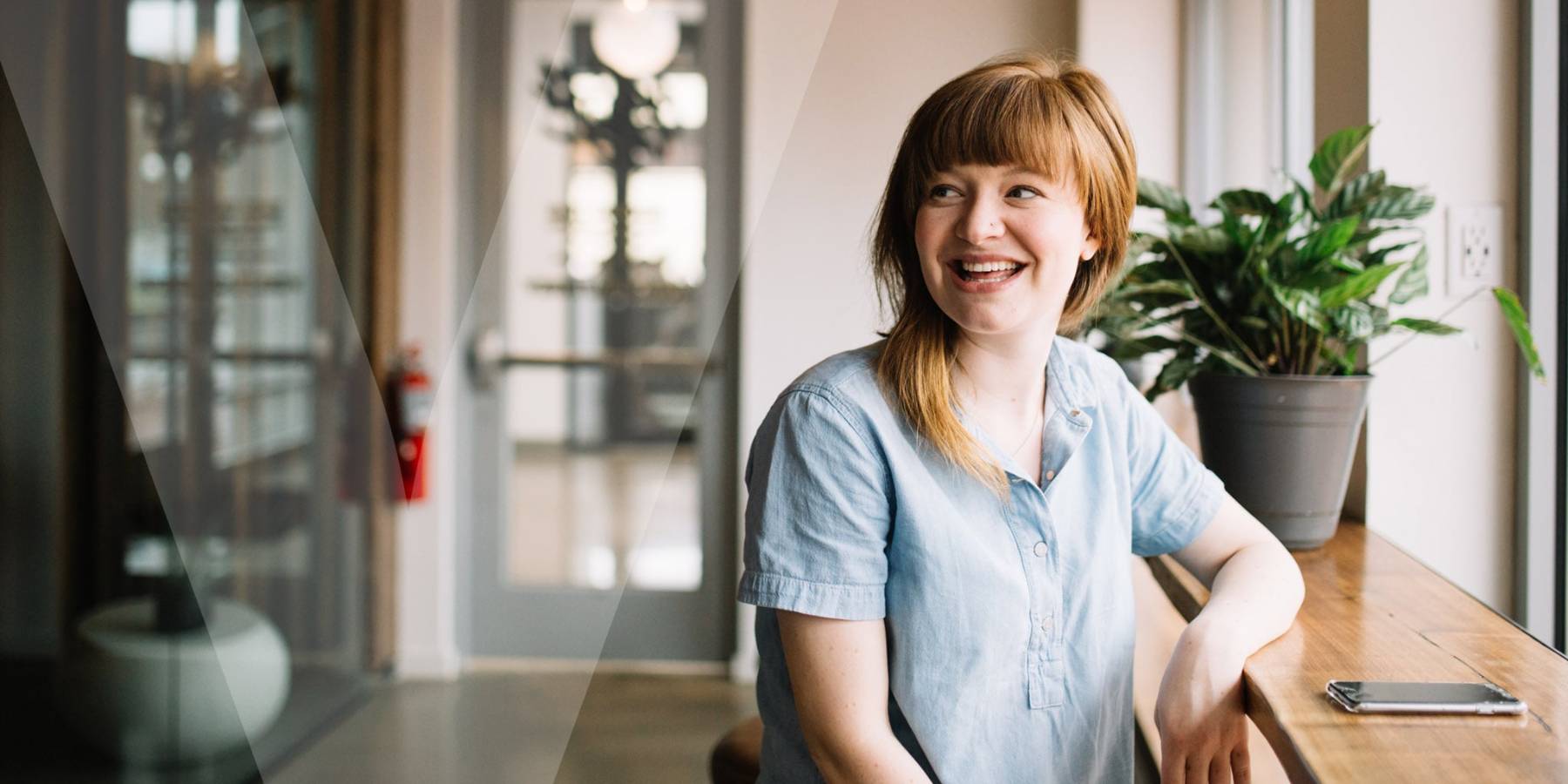 A woman looking back and smiling sitting in a café
