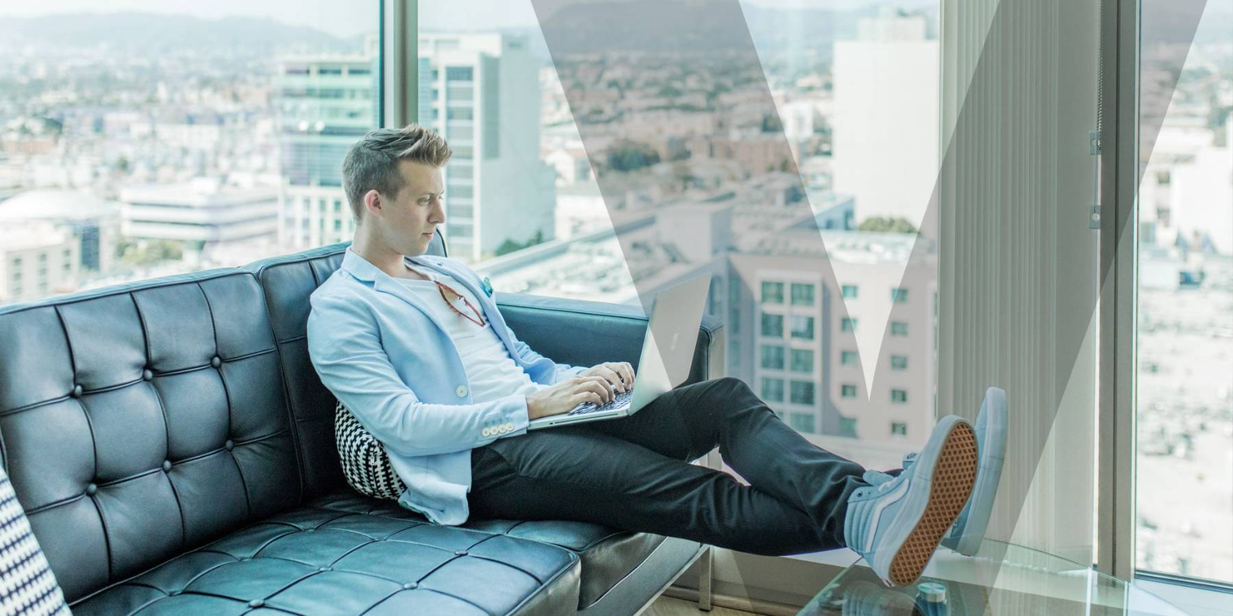 A person sitting on a couch and working from home