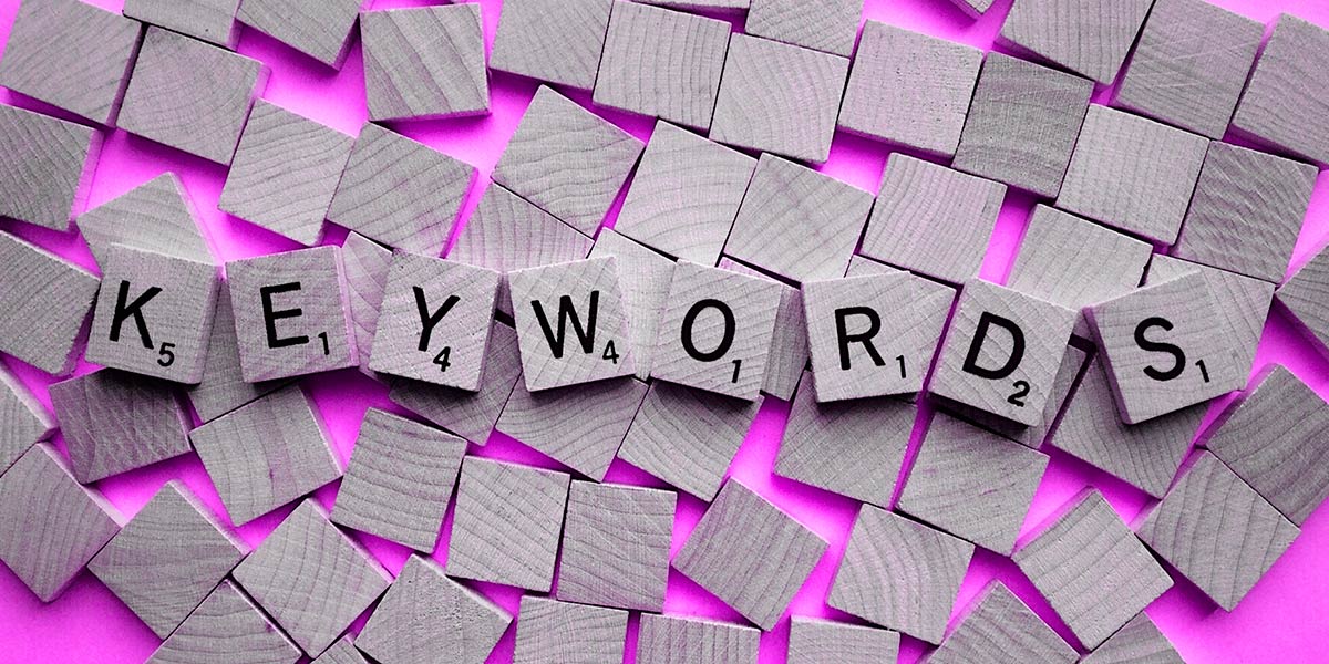Scrabble tiles depicting the word "Key words"