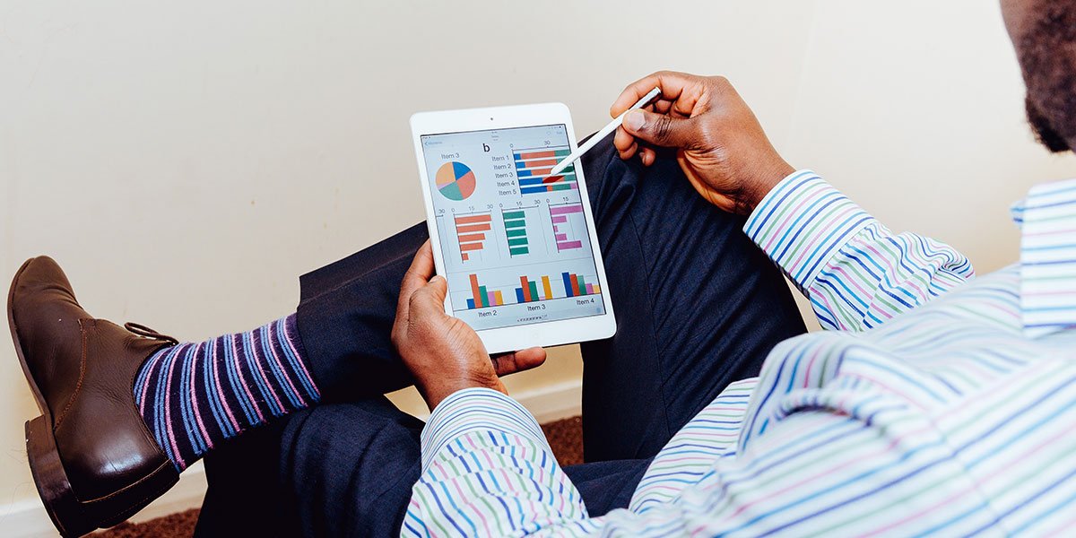 A Person looking at stats on a tablet