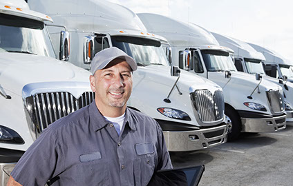 Truck driver and a row of white semi trucks