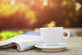 Cup of coffee and newspaper