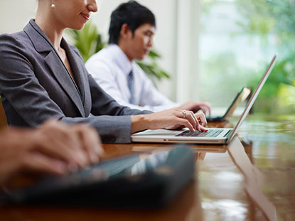 3 business people working on laptops