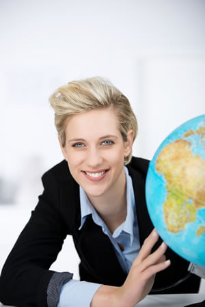 Businesswoman posing next to a globe