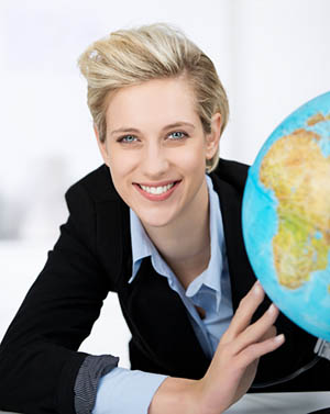 Businesswoman posing next to a globe