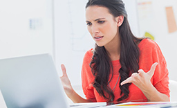 Disgruntled woman looking at a computer screen