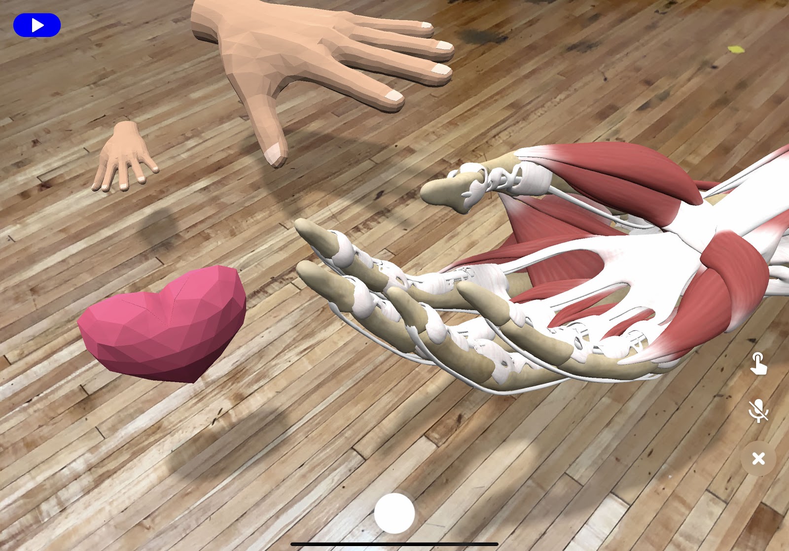 Models of 3D hands floating in an AR scene with shadows on the floor beneath them.