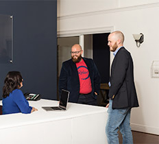 Robin Realty team members talking in the lobby
