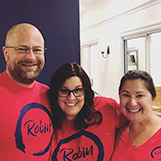 The Robin Realty team taking a photo with a client