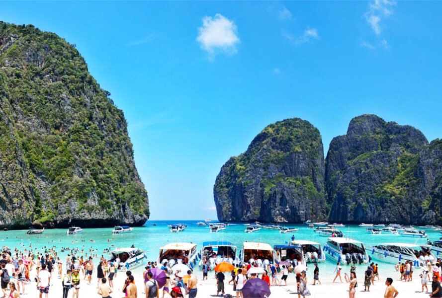 tourists and tour boats covering Maya Bay