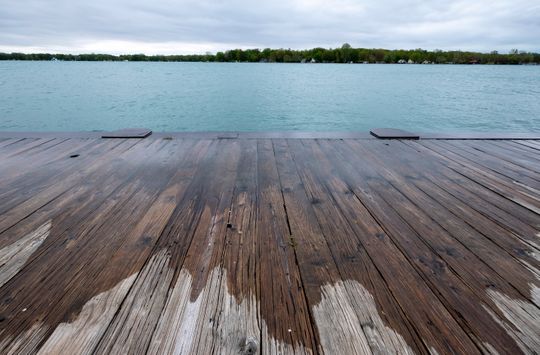 Waves lap from the St. Clair River over the boardwalk in Algoanc Monday, May 20, 2019.