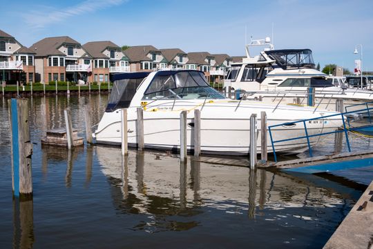 A boat sits in a slip at River Street Marina Tuesday, May 21, 2019, next to a dock that is partially submerged in the Black River.