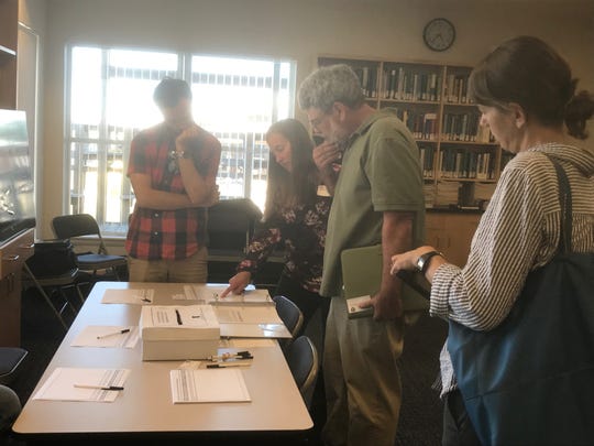 Members of the public look at displays during an informational meeting about an Army Corps proposal for beneficial use of dredge spoils in Wachapreague, Virginia on Tuesday, June 4, 2019.
