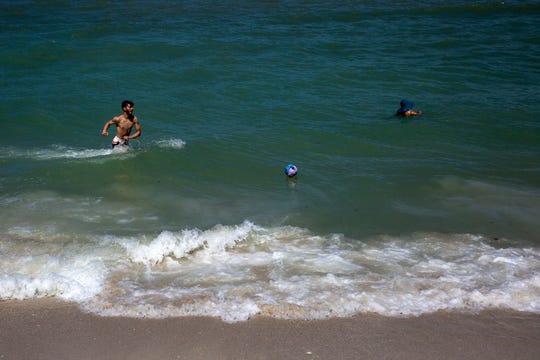 Beach goers enjoy swimming and playing in the Gulf at Clam Pass beach, Tuesday, June 11, 2019, in Naples.