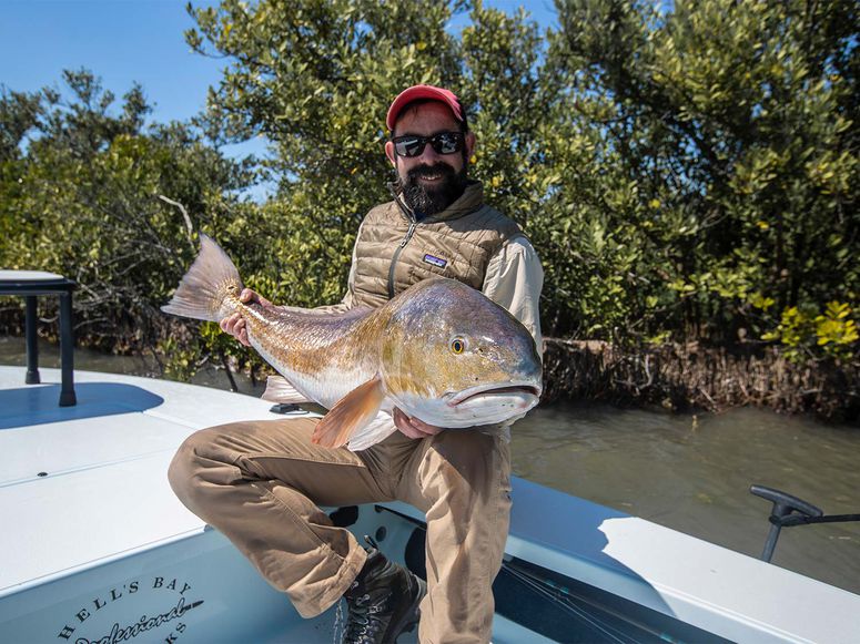andrew mckean holding giant bull redfish
