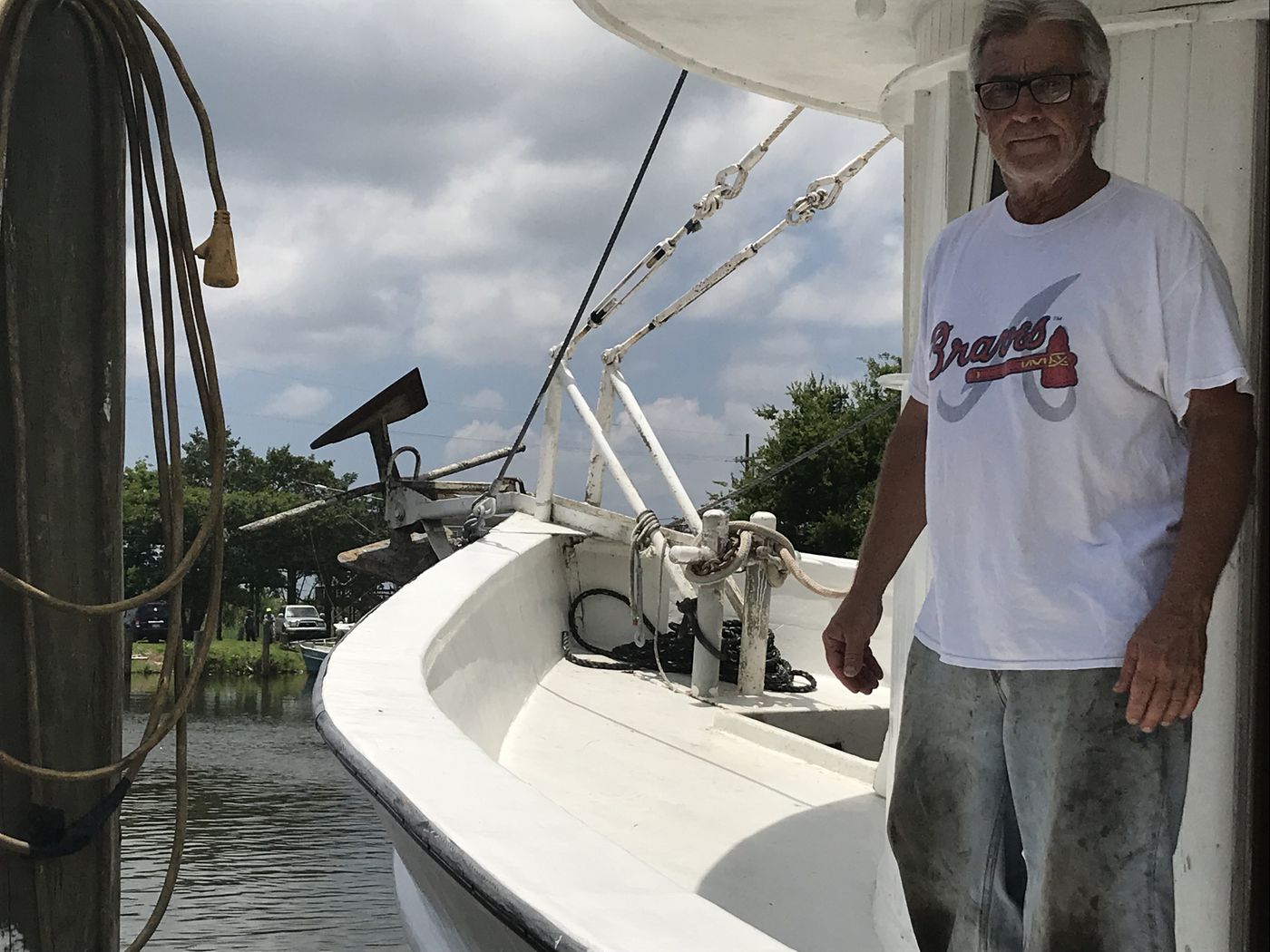 Capt. George Barisich stands at the front of his shrimping boat, the Peruga. Barisich has faced a number of challenges in recent years, including Hurricane Katrina and the BP oil spill. This year, he said Midwest flooding has caused an unprecedented amount of fresh water to pour into the Gulf from the Mississippi River, meaning shrimp are either dying or moving out of the area. (Jamie Grey/InvestigateTV)