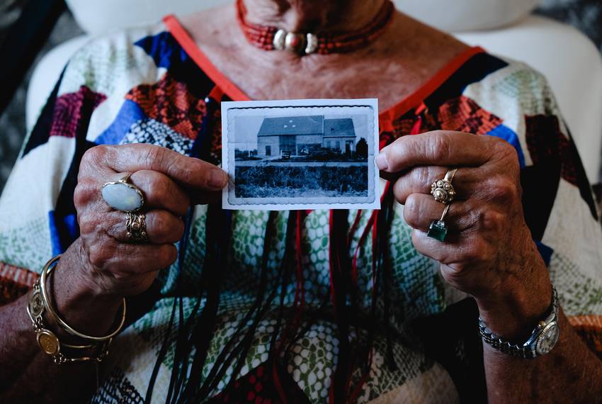 Mina Verton holds up a photo of her family's farmhouse, which was swept away in the 1953 North Sea flood.