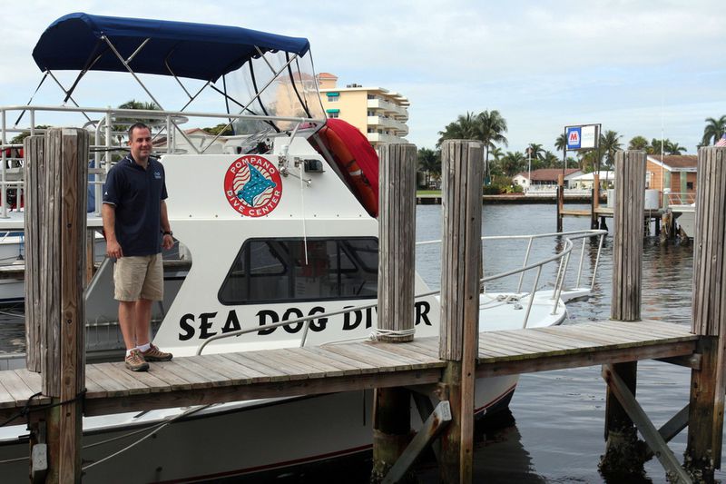 Pompano Dive Center's Bryan Armstrong with the Sea Dog Diver boat that ventures out to the SS Copenhagen shipwreck off Pompano Beach.