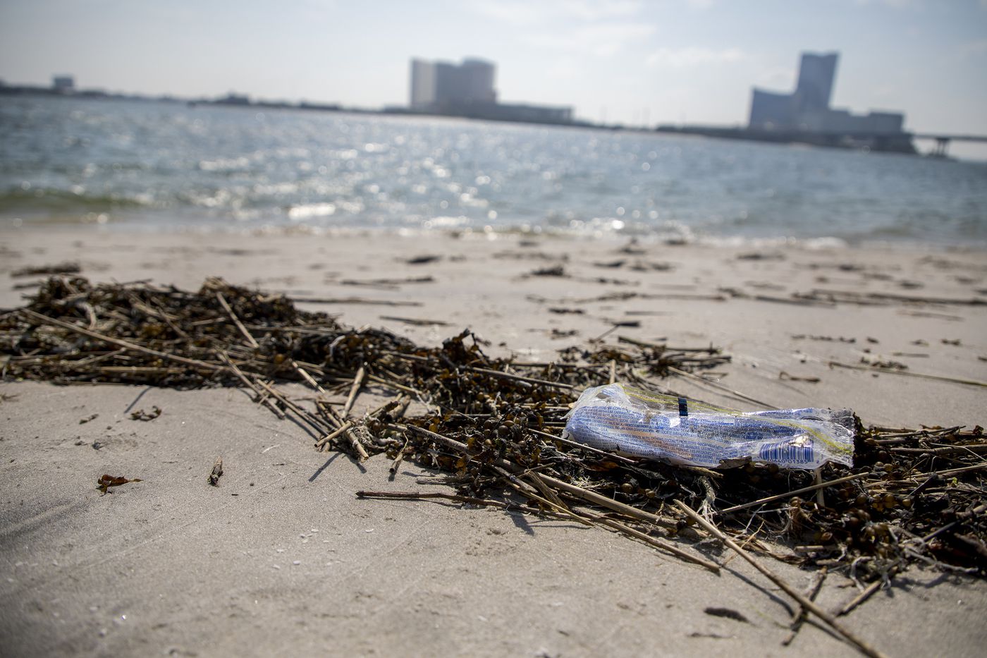 A piece of trash on the beach in Brigantine, N.J., on Wednesday, July 17, 2019. Locals are upset about how the beach is treated and clean up trash by bringing trash bags.