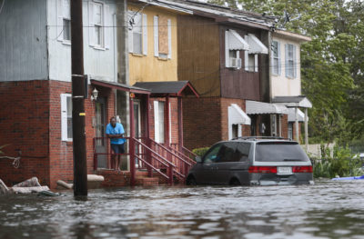 A man on his porch in Charleston, South Carolina after Hurricane Matthew caused flooding in October 2016.