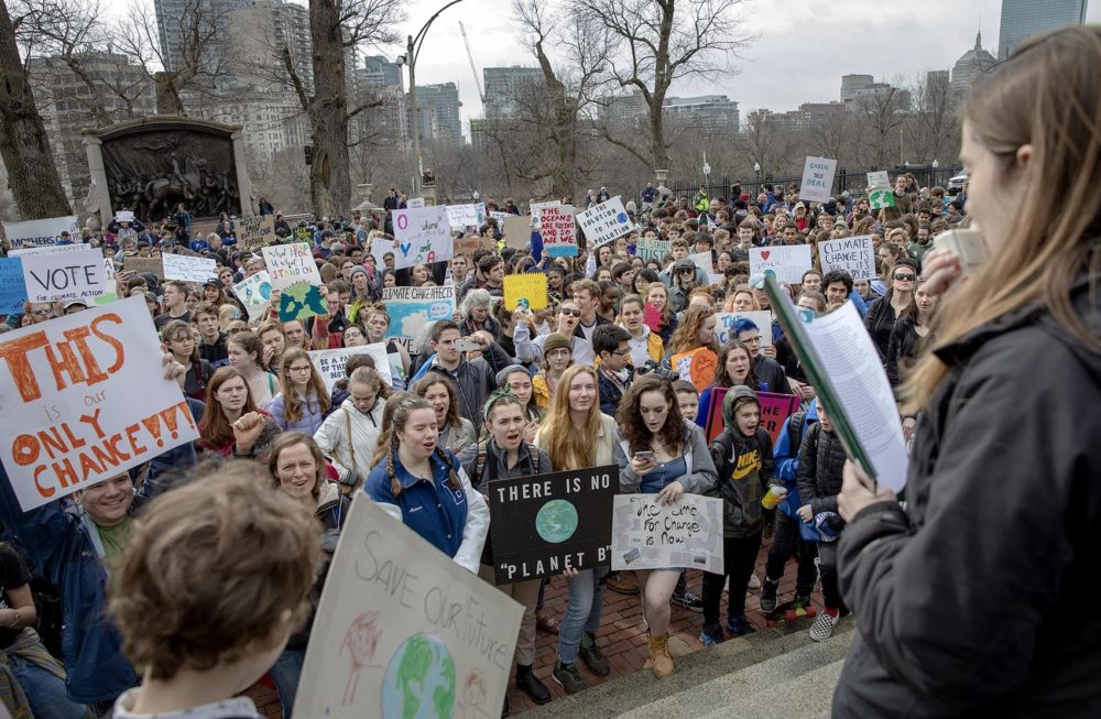 Students and supporters of the Massachusetts Youth Climate Strike crowd around the steps of the State House in Boston. (Robin Lubbock/WBUR)