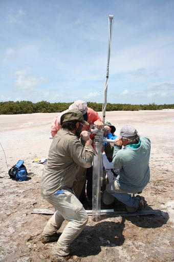 Scientists drill a piston core in Florida Bay sediment