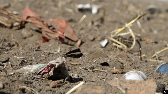 In this Sept. 9, 2018 photo, plastic waste sits on a freshly cultivated field in Nauen, Germany. (AP Photo/Ferdinand Ostrop)