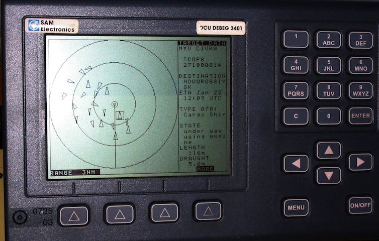 An electronic screen shows triangles, representing nearby ships, within concentric circles.