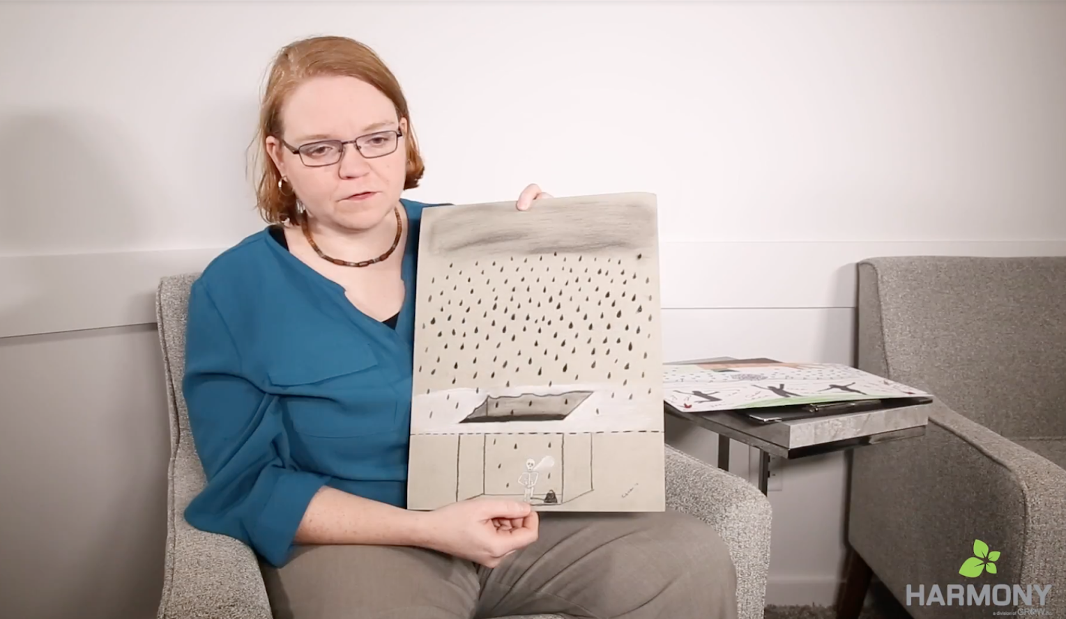 patient holds her art showing how depression feels
