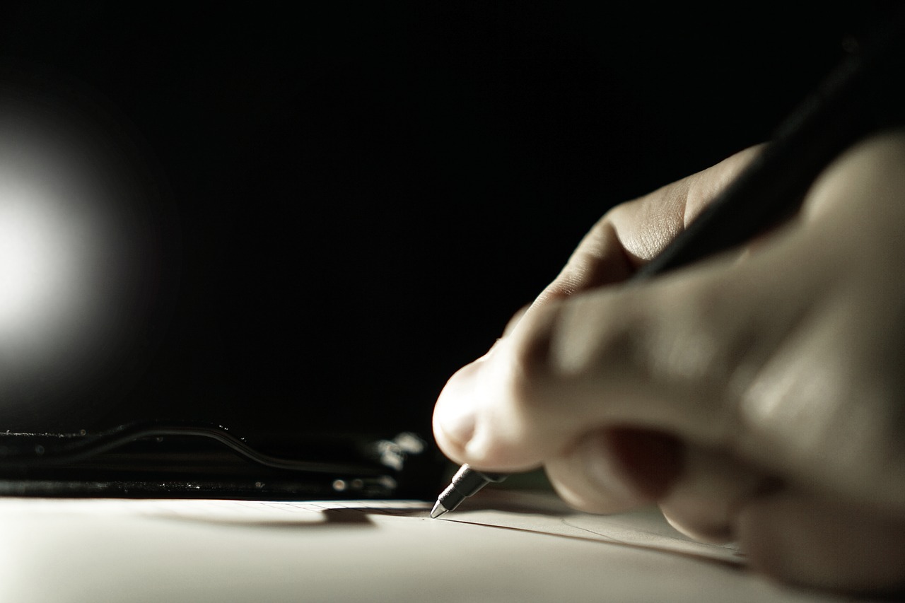 hand writing with a pen on paper