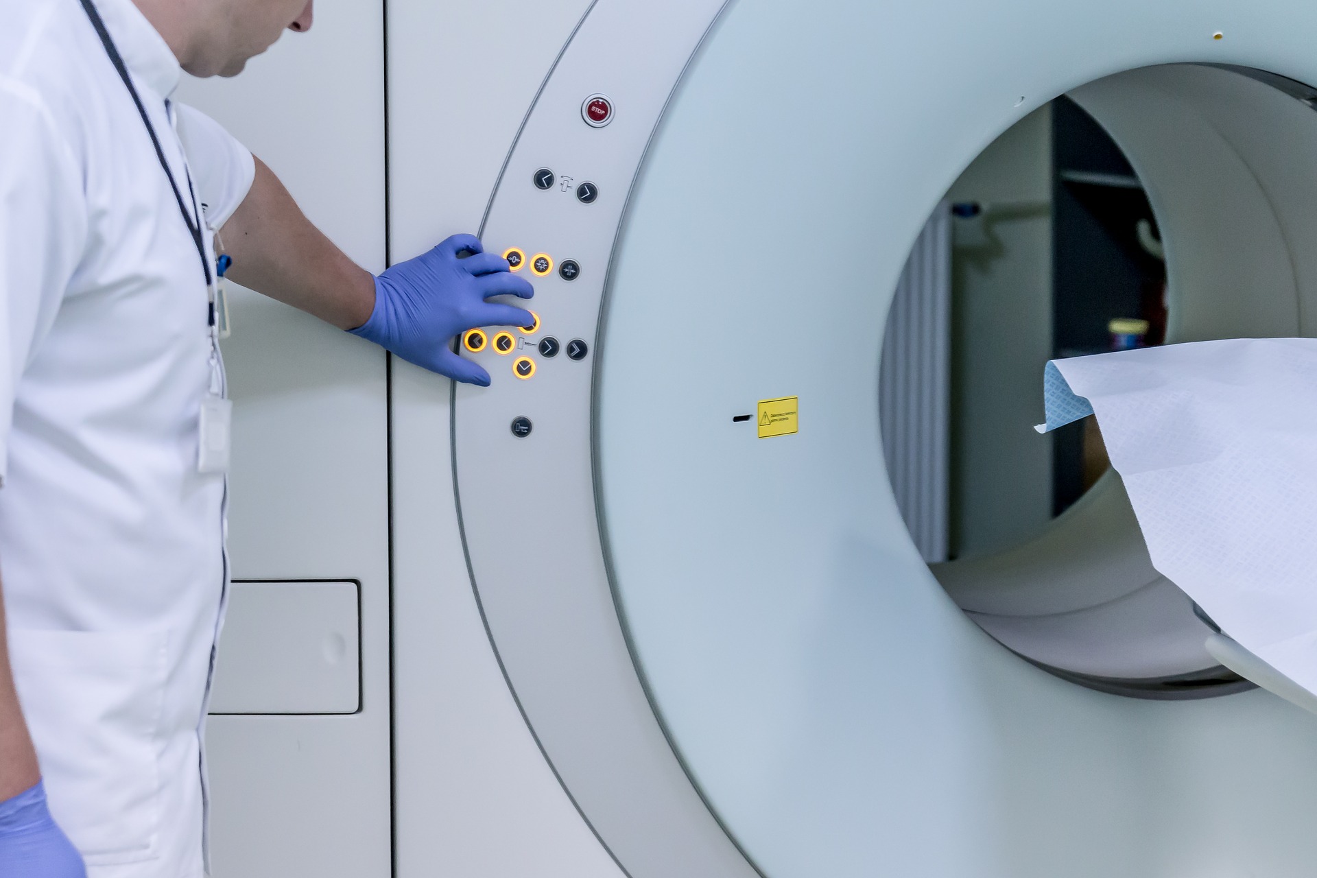 doctor presses buttons on fMRI machine