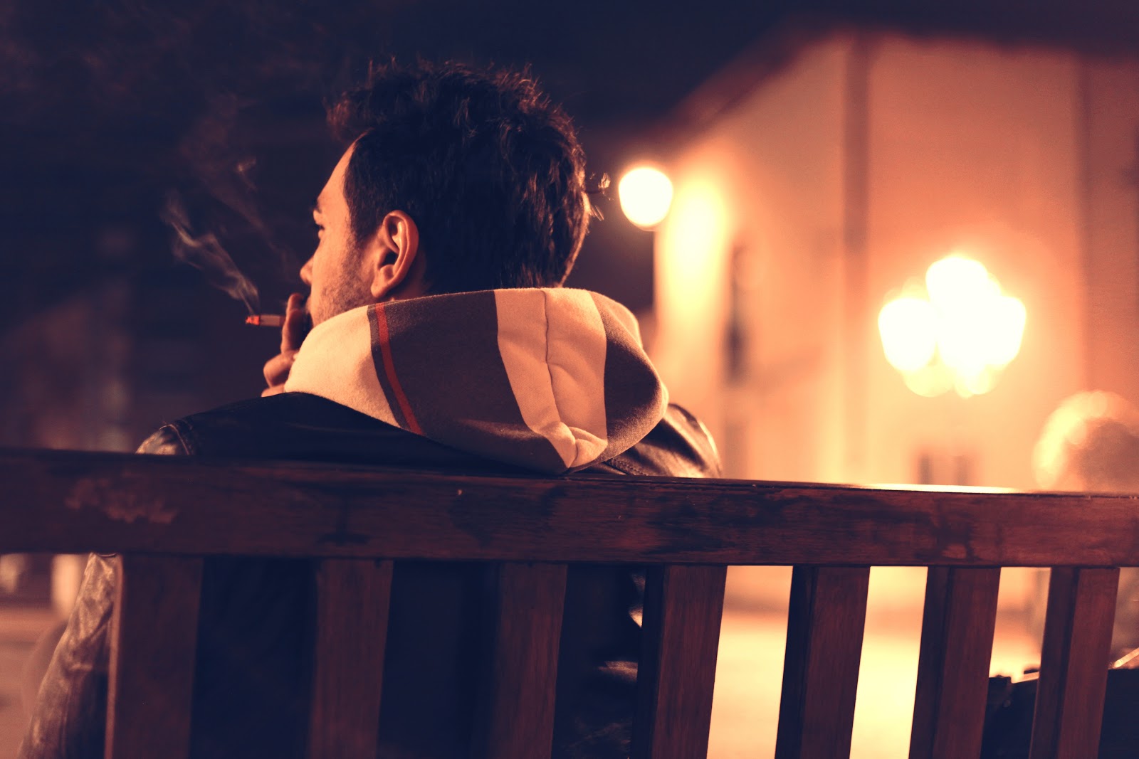 Man Smoking cigarette on bench