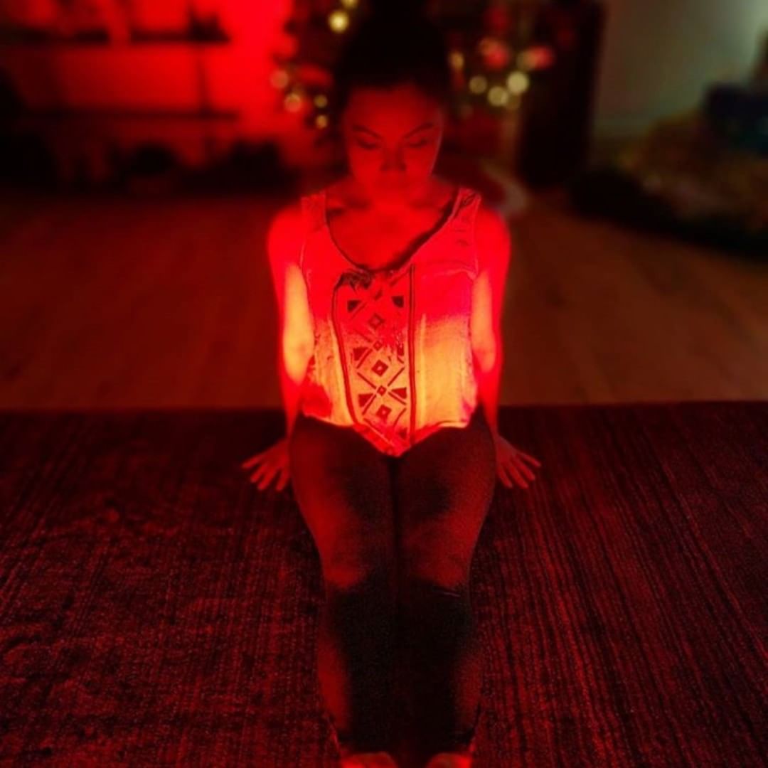 Woman meditating in red light