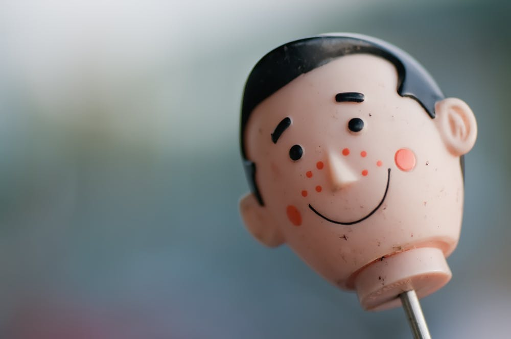 a toy doll's head smiles