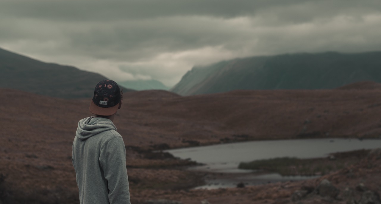 man looking at reservoir