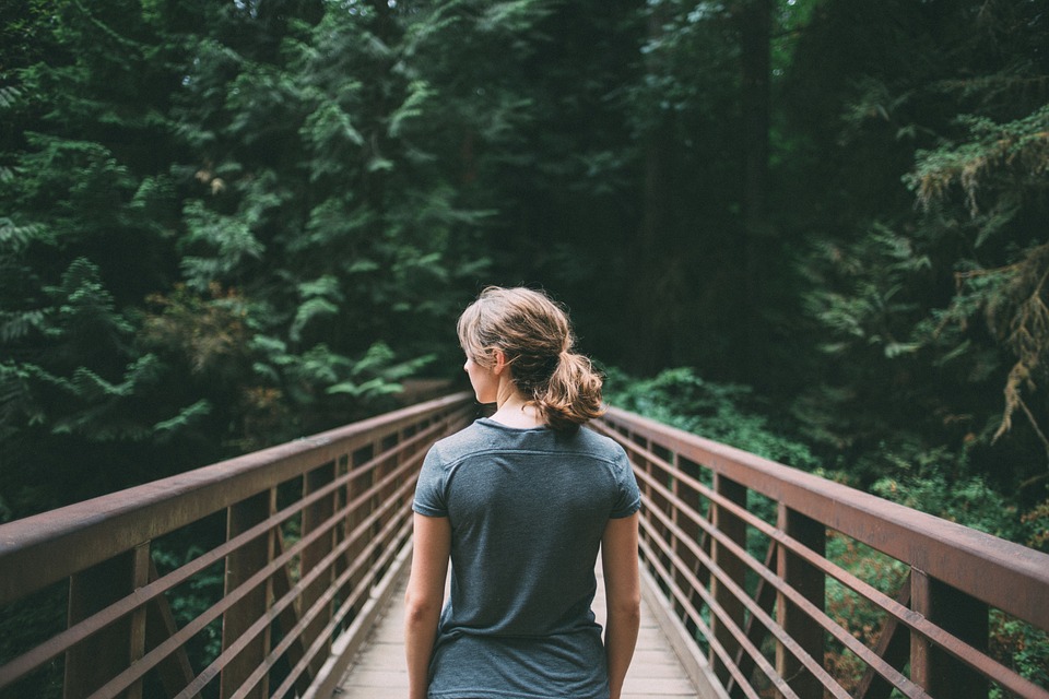 Woman crosses bridge