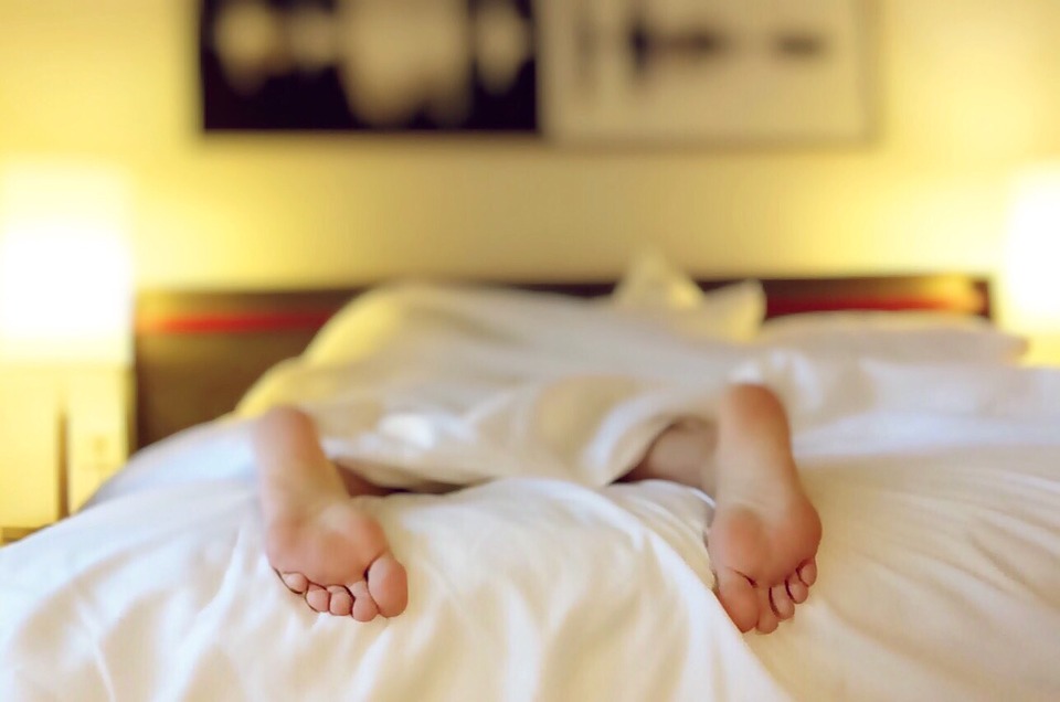 Woman sleeping in hotel bed
