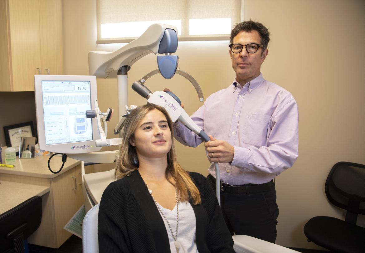 Female patient being treated with NeuroStar TMS therapy.