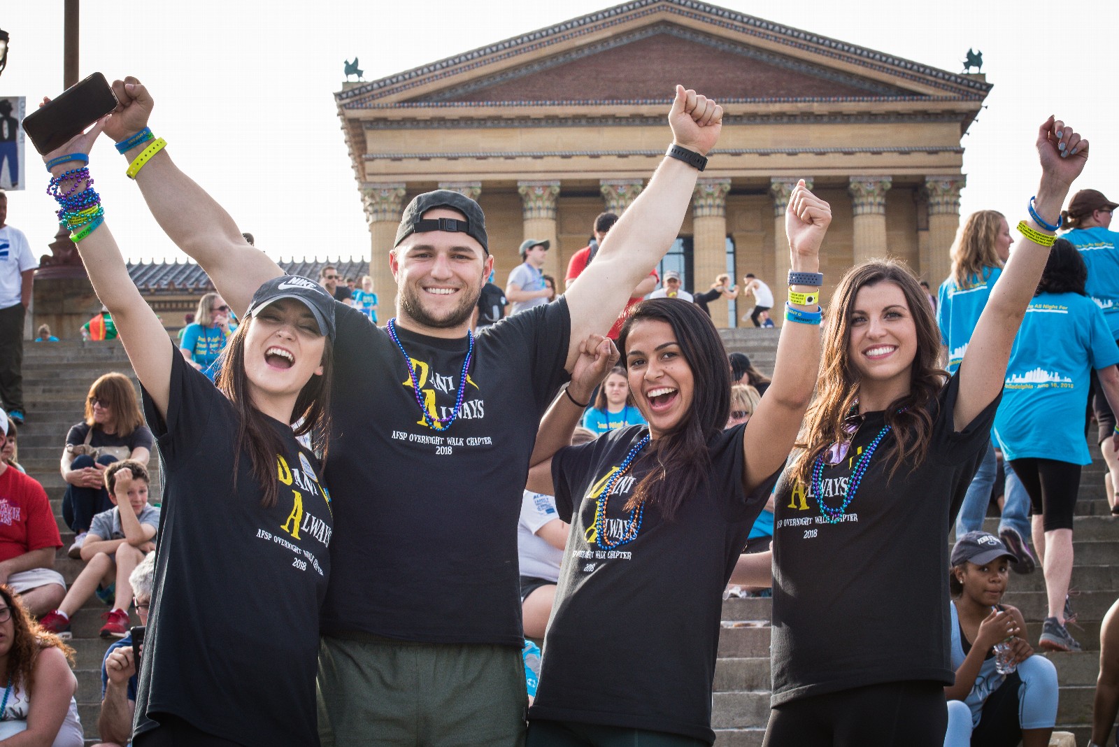 Walkers in the Out of the Darkness Overnight Walk stand outside the Philadelphia Museum of Art.