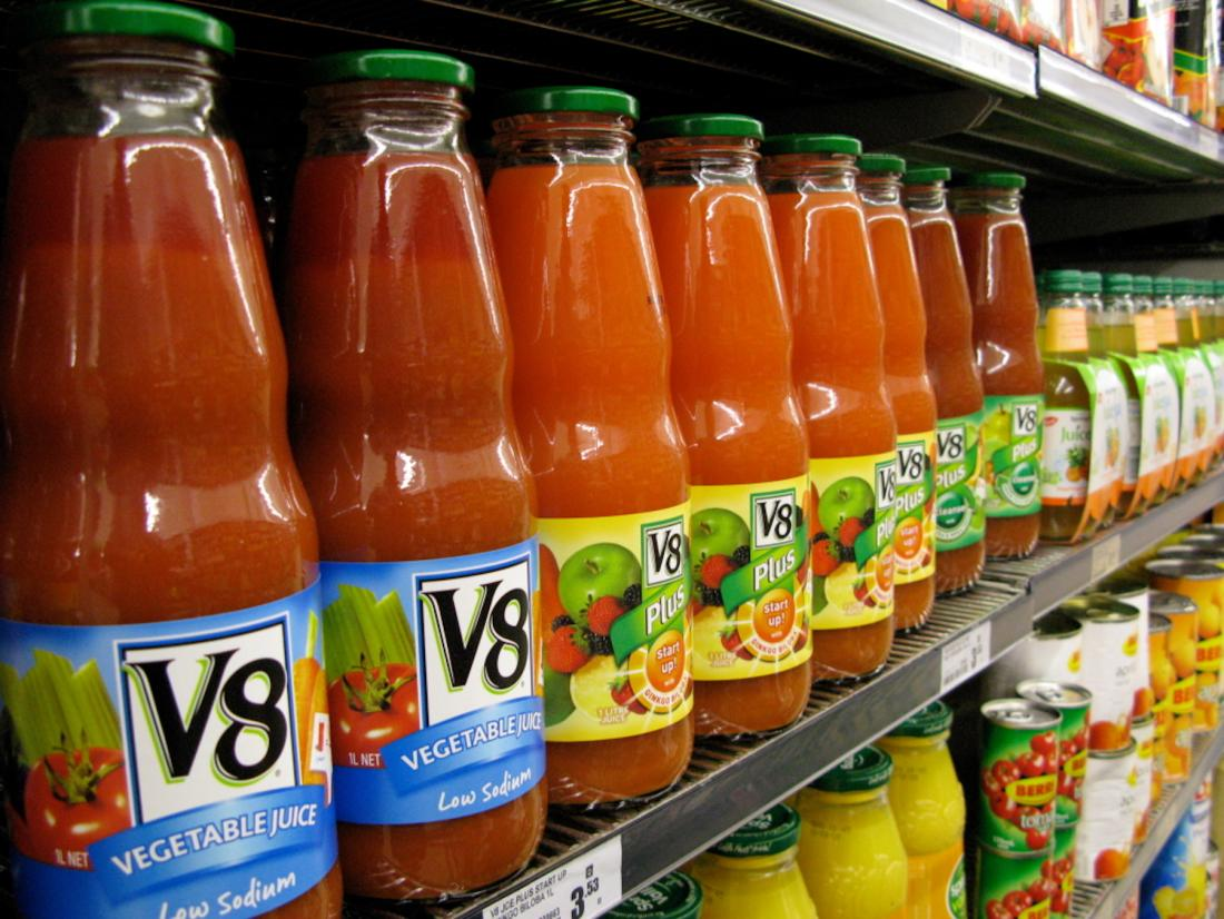 V8 bottles on display at grocery store.