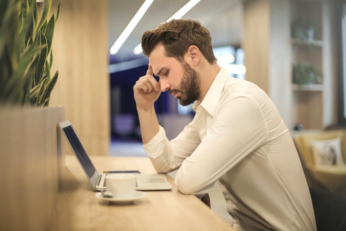 A man sits attempting to solve a problem, which utilizes his working memory.