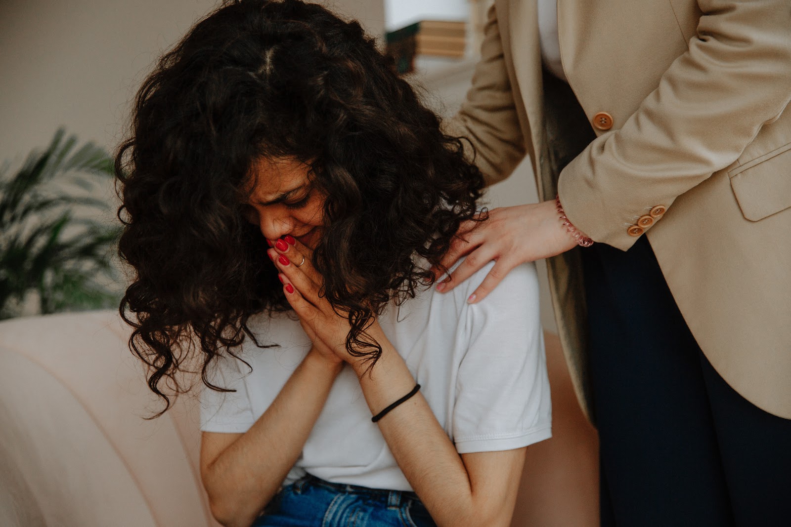 Woman being comforted by therapist