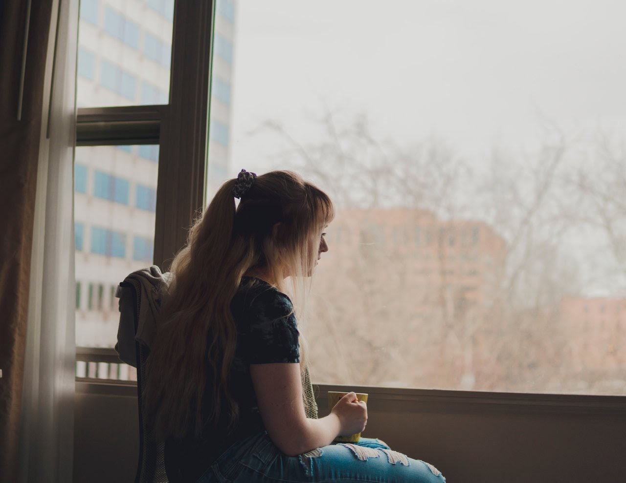 Girl staring blankly out of window