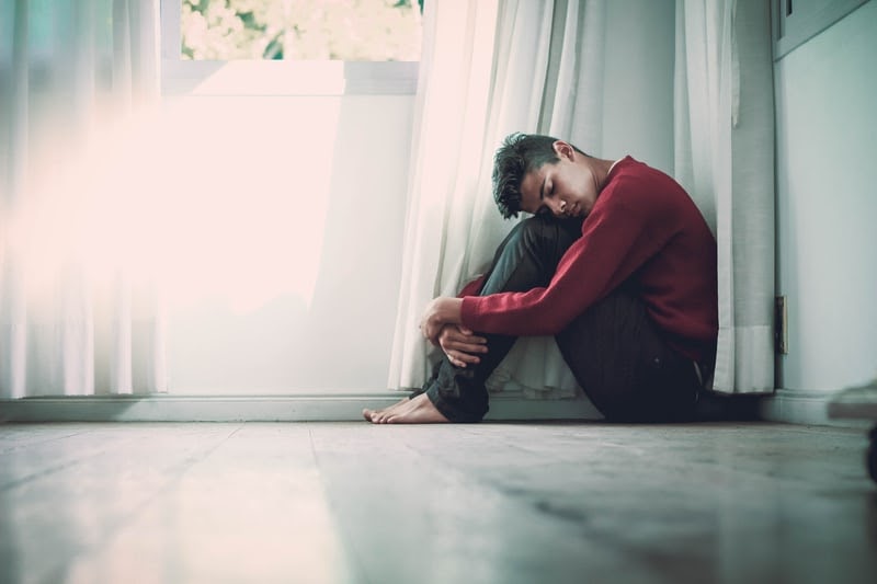 Person huddled in anxiety
