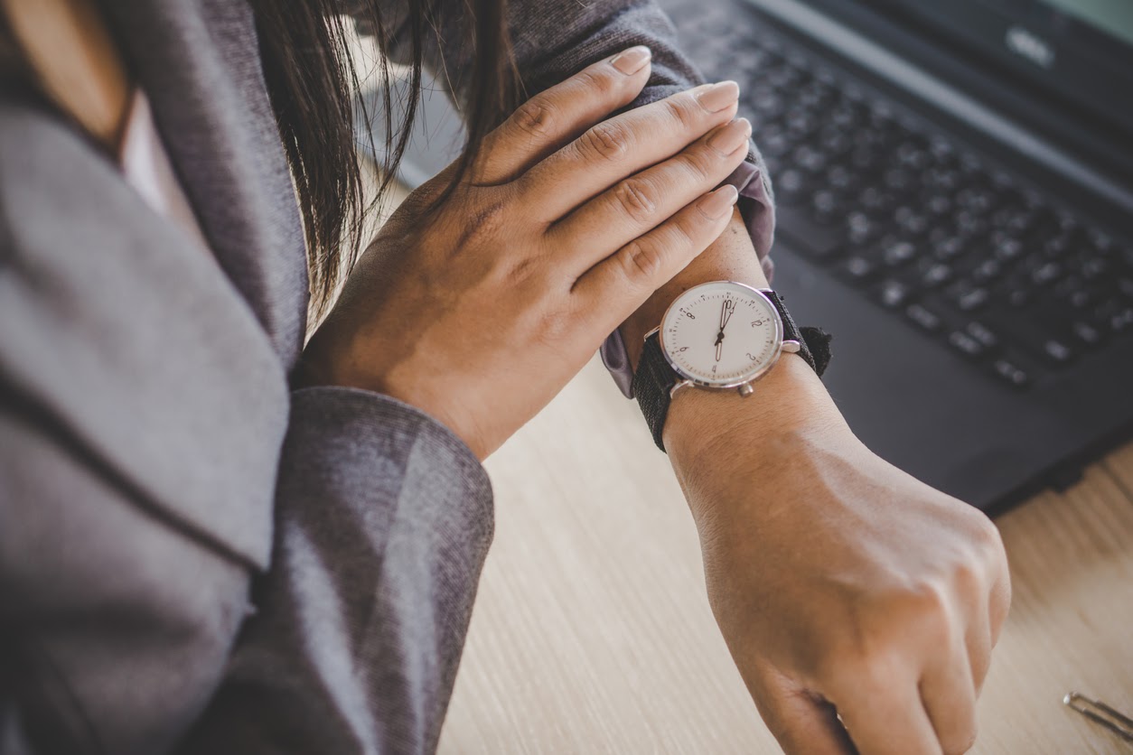 woman checking watch to see if late for TMS treatment
