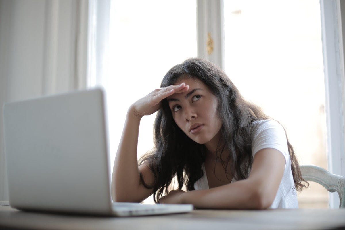 woman researching different TMS treatments on laptop