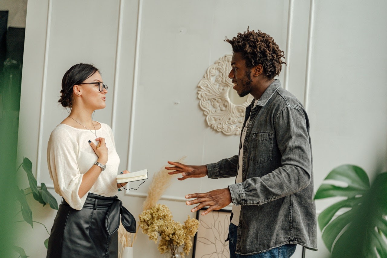 A young man has a conversation with his therapist in her office