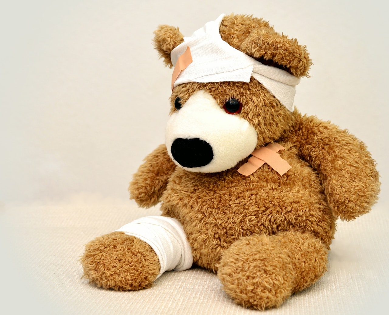 patched up teddy bear with bandages