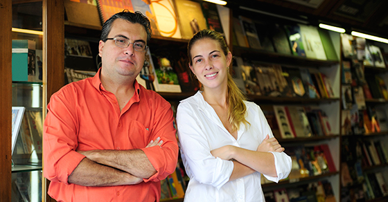father and daughter standing in bookstore