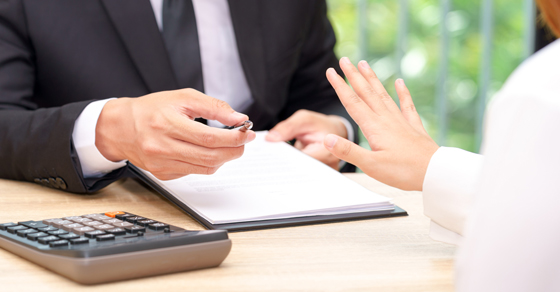 man offering pen to sign contract